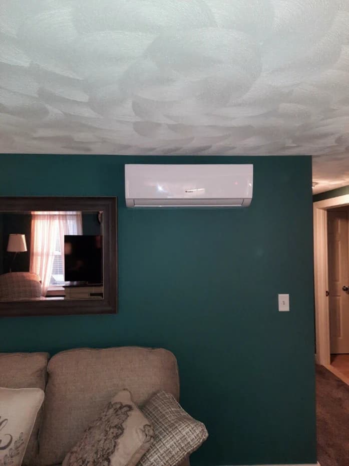 A wall-mounted ductless head in a finished living room